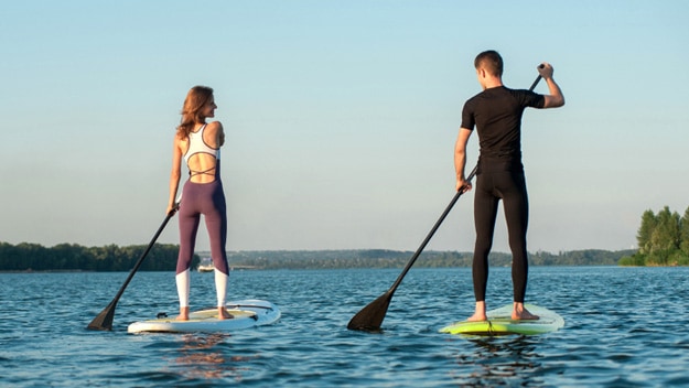 man-woman-paddle-boarding-on-river-ss | Places to Play Different Kinds of Sports in Thao Dien